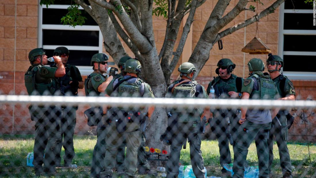 Law enforcement officials stand outside the school following the shooting. The FBI and the Bureau of Alcohol, Tobacco, Firearms and Explosives have been assisting local police with the investigation.