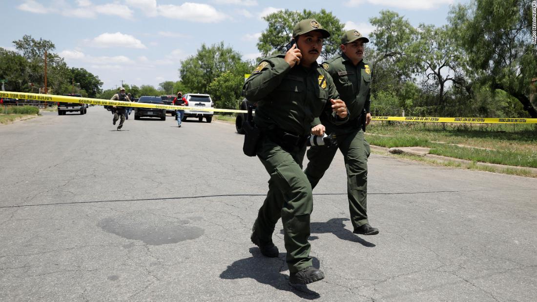 Law enforcement personnel run near the scene of the shooting on May 24. US Customs and Border Protection, which is the largest law enforcement agency in the area, assisted with the response.