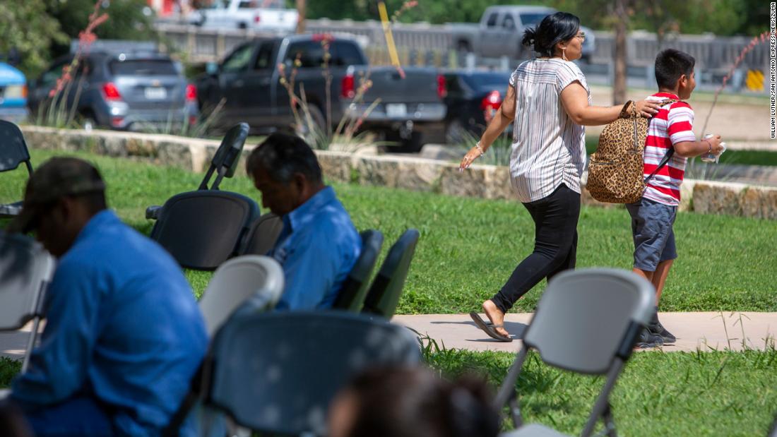 A woman and a child leave the Uvalde civic center on Tuesday.