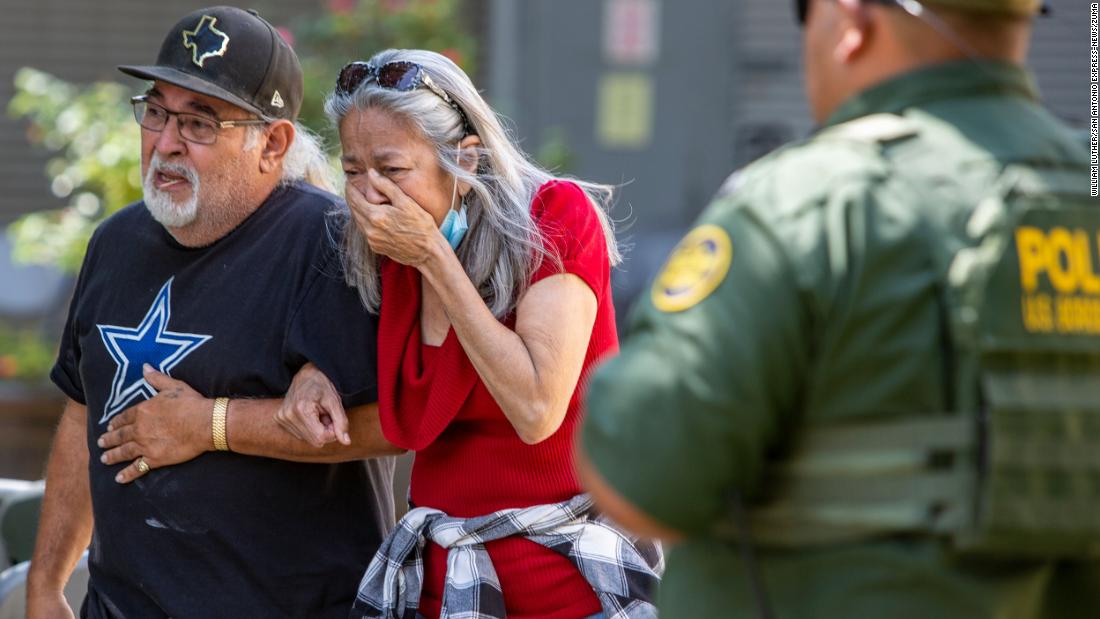 A woman cries as she leaves the civic center. 