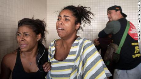 People react as victims arrive at the Getulio Vargas Hospital on May 24, 2022. 