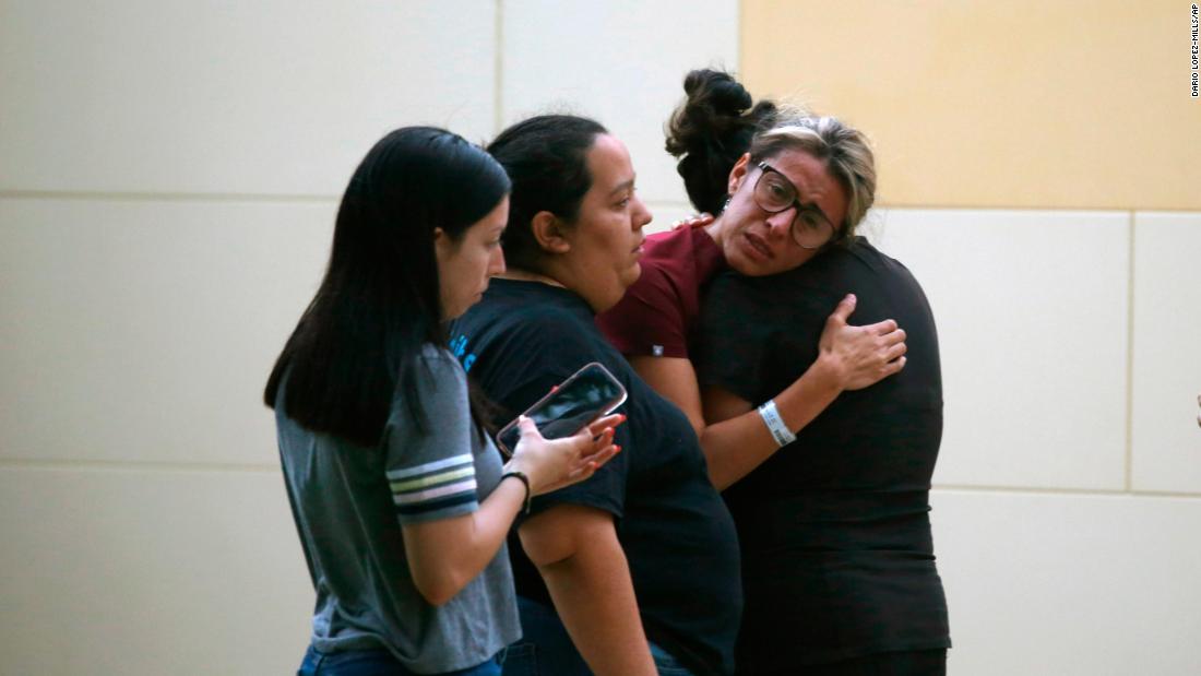 People comfort each other outside the civic center in Uvalde.