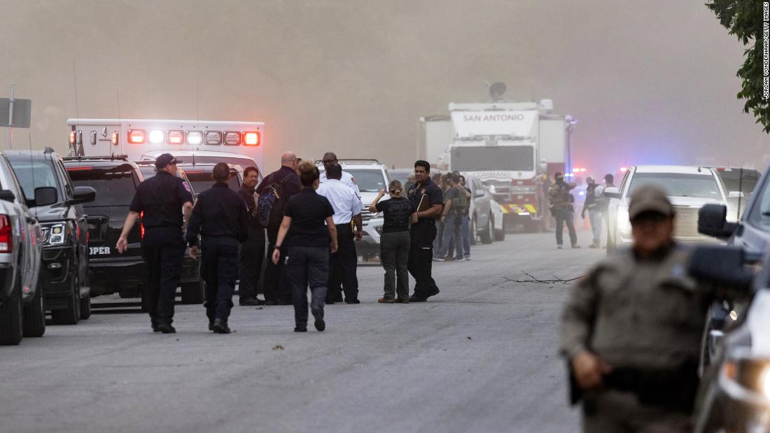 Law enforcement officials work the scene after the shooting on May 24.