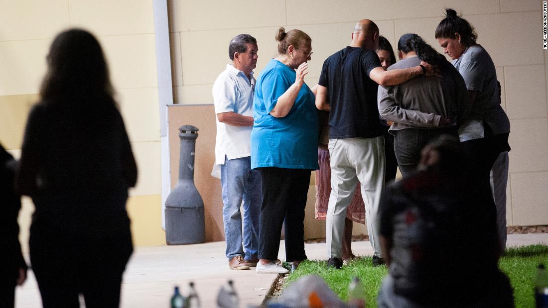 People pray outside the SSGT Willie de Leon Civic Center in Uvalde on May 24. The civic center is where students were transported after the shooting.