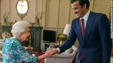 Britain&#39;s Queen Elizabeth II shakes hands with the Emir of Qatar Sheikh Tamim bin Hamad al-Thani during an audience at Windsor Castle, west of London on Tuesday. Britain said it had agreed a new investment partnership with Qatar on Tuesday which will see the Gulf state invest up to 10 billion pounds ($12.5 billion) in the next five years. 