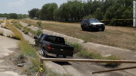 A police vehicle is seen parked near a truck believed to belong to the suspect on May 24, 2022.