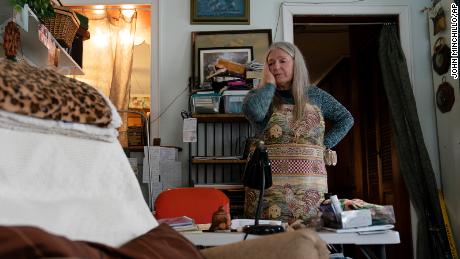 Nancy Rose, who contracted COVID-19 in 2021 and continues to exhibit long-haul symptoms including brain fog and memory difficulties, pauses while organizing her desk space, Tuesday, Jan. 25, 2022, in Port Jefferson, N.Y. Rose, 67, said many of her symptoms waned after she got vaccinated, though she still has bouts of fatigue and memory loss. A report from the Centers for Disease Control and Prevention released on Wednesday, May 25, 2022, found that up to a year after an initial coronavirus infection, 1 in 4 adults aged 65 and older had at least one potential long COVID health problem, compared with 1 in 5 younger adults. 