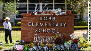 Flowers are placed on a makeshift memorial in front of Robb Elementary School in Uvalde, Texas, on May 25, 2022. - The tight-knit Latino community of Uvalde was wracked with grief Wednesday after a teen in body armor marched into the school and killed 19 children and two teachers, in the latest spasm of deadly gun violence in the US.