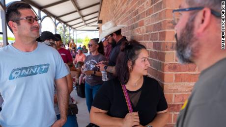 Michael Cavasos, 40, left, Brenda Perez, 39, right, and Eduardo Galindo, 57, wait in line to donate blood the day after the deadly mass shooting.