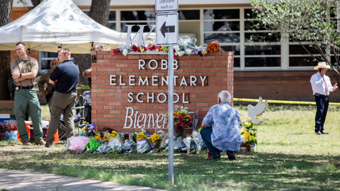 Flowers are seen at the memorial in front of the school.