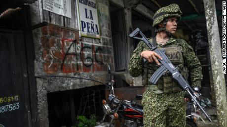 A Colombian soldier stands guard outside the port city of Buenaventura, Colombia, this month.