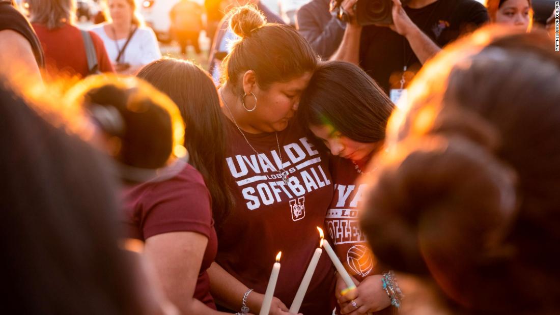 People in Uvalde light candles during a memorial for the shooting victims on May 25.