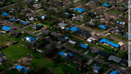 Blue tarps cover the roofs of homes, which were damaged after Hurricane Laura and Hurricane Delta landed in southwest Louisiana in Lake Charles, Louisiana on October 11, 2020. (Photo by Callaghan OHare for The Washington Post via Getty Images)
