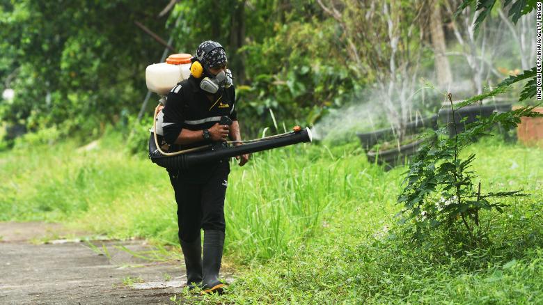 A worker sprays insecticide to fight against dengue fever in Singapore, July 6, 2021.