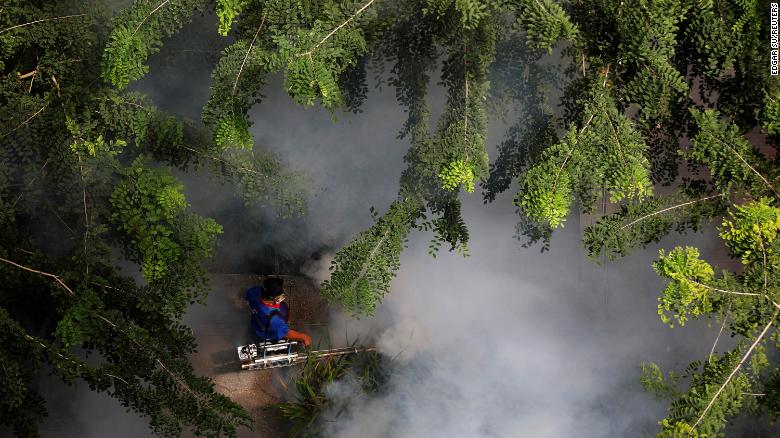 A worker fogs a housing estate for mosquitoes in Singapore on August 27, 2020.