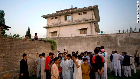निवासी एक घर के बाहर इकट्ठा होते हैं, जहां अल कायदा नेता ओसामा बिन लादेन को 3 मई, 2011 को पाकिस्तान के एबटाबाद में पकड़ा गया था और मार दिया गया था।