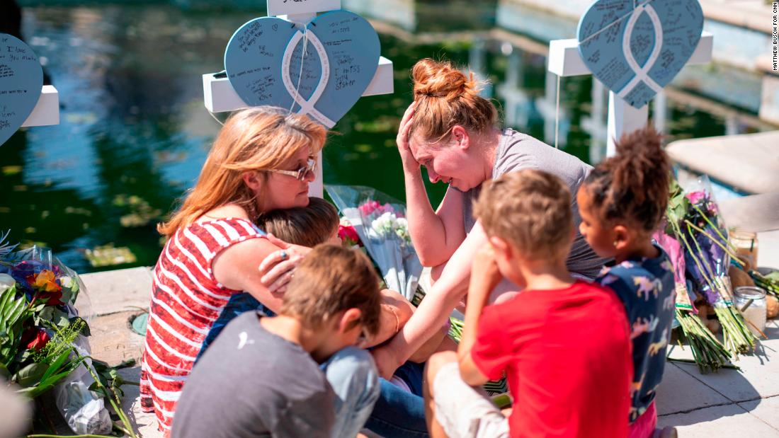 The friends and family of Miranda Mathis grieve her loss in front of a cross bearing her name on Thursday, May 26. &quot;These children should be remembered for all the right reasons,&quot; a family member said.