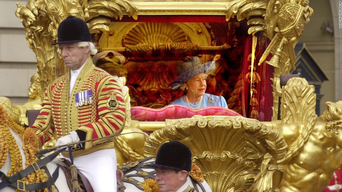 Britain&#39;s Queen Elizabeth II and her husband Prince Philip, unseen, ride in the State Gold Coach enroute to St. Paul&#39;s Cathedral in London, Tuesday June 4, 2002, for a service of thanksgiving to mark her Golden Jubilee. 
