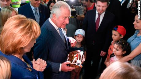 Prince Charles and Princess Margaret, the Custodian of the Romanian Crown, offer presents to Ukrainian refugees during a visit at a donation center in Bucharest, Romania on Wednesday.