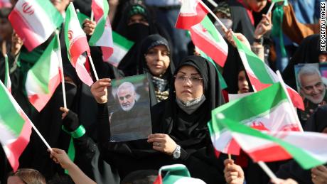 An Iranian carries a portrait of the slain chief of Iran&#39;s Islamic Revolutionary Guard Corps&#39;s Quds Force, Qasem Soleimani, during a gathering at the Azadi stadium in the capital Tehran on May 26 to attend a performance of the song &quot;Salam Farmandeh&quot; (&quot;Salute Commander&quot;). The song addresses the younger generation, and serves as a &quot;salute&quot; to the Mahdi, the 12th imam of Shiite Islam, whom they believe disappeared centuries ago and will return one day to usher in a new era of peace and justice. 