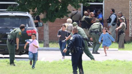 Students run to safety after escaping from a window at Robb Elementary School on Tuesday, May 24.