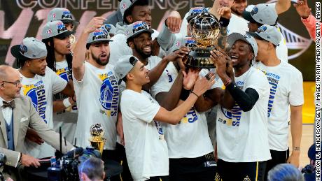 The Warriors celebrate with the Western Conference Champion trophy after a 120-110 win against the Dallas Mavericks.