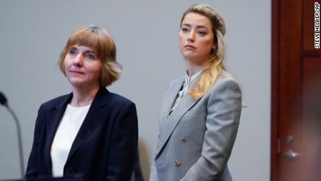 Amber Heard stands with her attorney attorney Elaine Bredehoft on Friday.