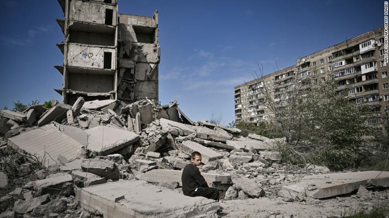 A boy sits on the rubble of a building hit in a strike on Kramatorsk, a city in the Donetsk region.