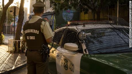 A police officer patrols the Yunge neighborhood of Santiago in April. 