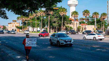 Alex Covarrubias carries a sign downtown that reads, &quot;Uvalde Strong,&quot; in Uvalde, Texas on Sunday, May 29, 2022. 

