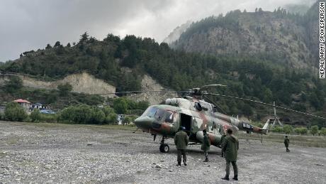 A military helicopter takes part in the search for the wreckage of the Tara Air flight.