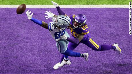 CeeDee Lamb of the Dallas Cowboys tries to catch Jeff Gladney of the Minnesota Vikings during an NFL game on November 22, 2020, in Minneapolis, Minnesota. 