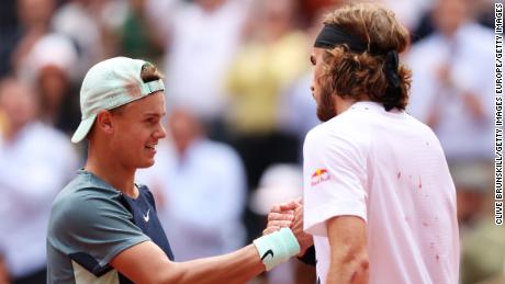 Rune and Tsitsipas meet at the net after the quarter-finals of the French Open. 