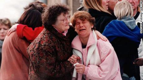 A group of parents near the elementary school in Dunblane, Scotland, where a gunman killed 16 children and a teacher in 1996.  