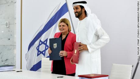 Israel&#39;s Minister of Economy and Industry Orna Barbivai and UAE Minister of Economy Abdulla bin Touq Al Marri present the free trade agreement they signed in Dubai, United Arab Emirates on May 31.  