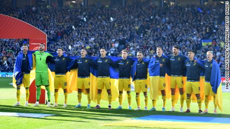 Ukrainian players, wearing their country's flag, lined up before the match. 