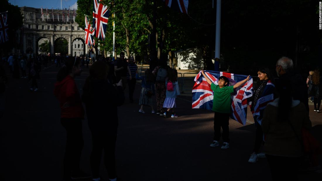 A boy poses with a Union flag on The Mall on Wednesday.