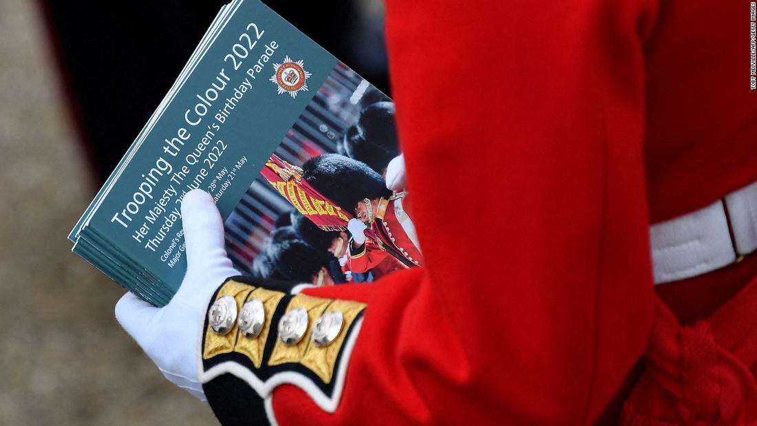 A member of the Coldstream Guards holds souvenir programs ahead of the start of Thursday&#39;s parade.