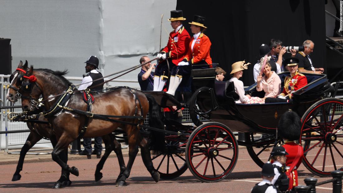 Prince Edward, right, rides in a carriage along with his wife Sophie, the Countess of Wessex, and their children, James and Louise.
