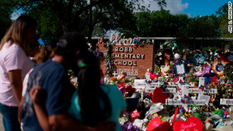 People visit a memorial at Robb Elementary School in Uvalde, Texas, Thursday, June 2, 2022, to pay their respects to the victims killed in last week's school shooting. 