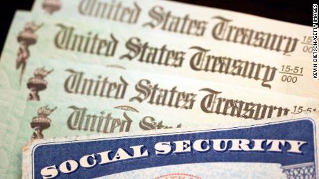 WASHINGTON, DC - OCTOBER 14: In this photo illustration, a Social Security card sits alongside checks from the U.S. Treasury on October 14, 2021 in Washington, DC. The Social Security Administration announced recipients will receive an annual cost of living adjustment of 5.9%, the largest increase since 1982. The larger increase is aimed at helping to offset rising inflation. 