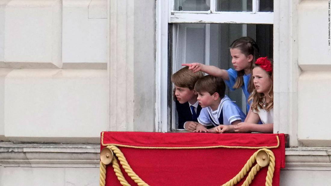 Four of the Queen&#39;s great-grandchildren watch the parade from a window of Buckinghamp Palace on Thursday. From left are Prince George, Prince Louis, Princess Charlotte and Mia Tindall.