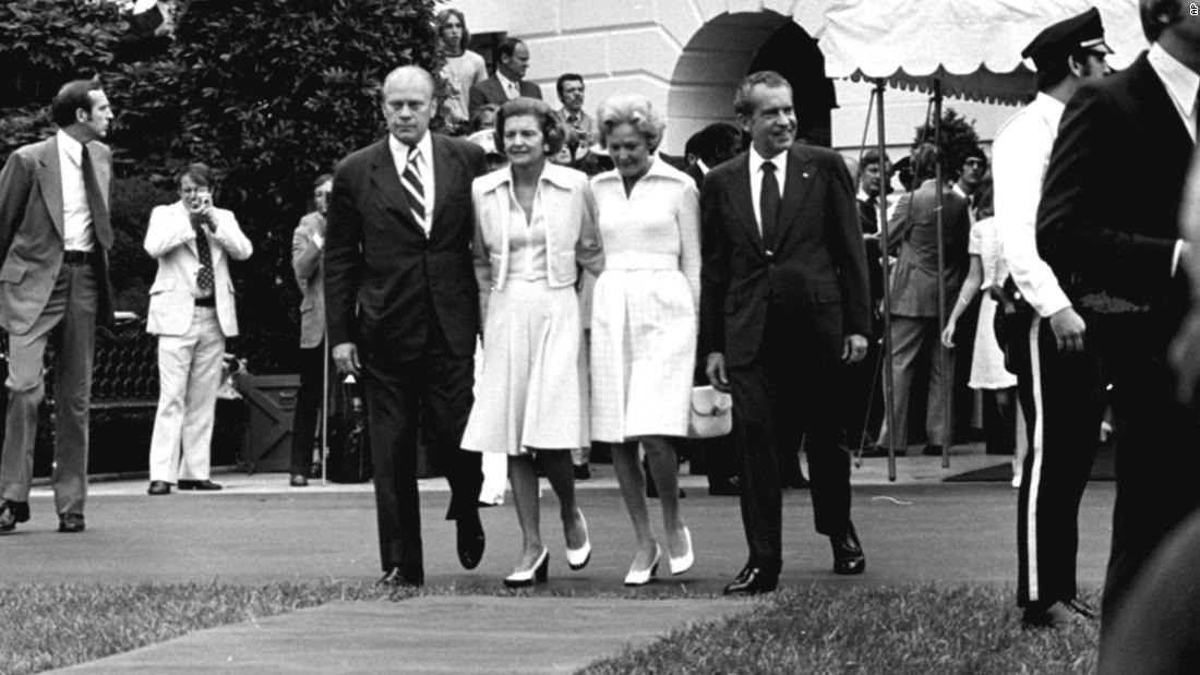 Nixon and his wife, Pat, walk out of the White House with Ford and his wife, Betty, before boarding Marine One. Nixon was pardoned by Ford a month later.