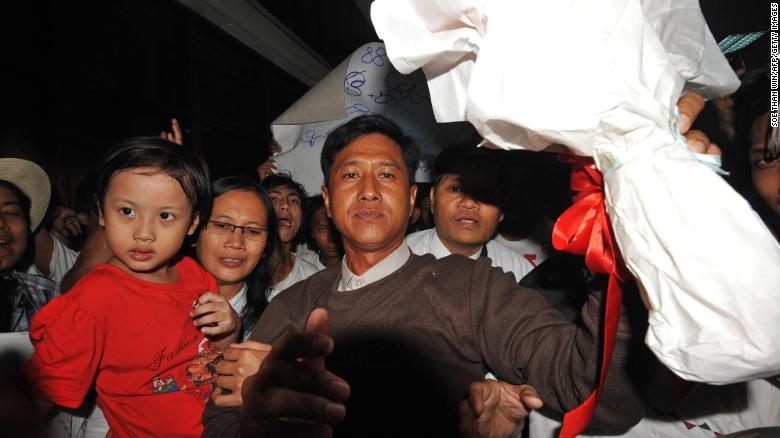 Myanmar political prisoner Kyaw Min Yu, center, and his wife Ni Lar Thein, left, upon their arrival at Yangon international airport following their release from detention on January 13, 2012.