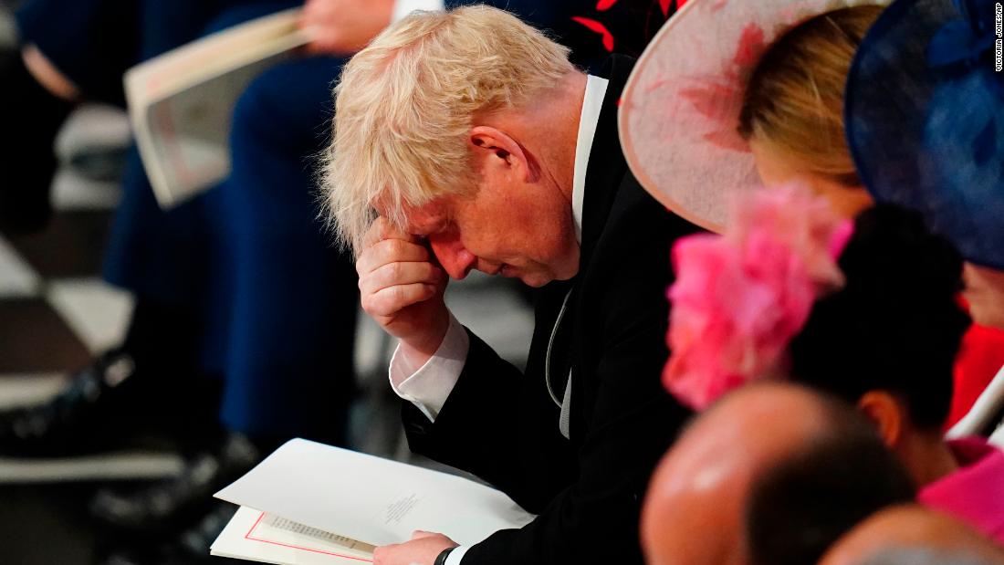 British Prime Minister Boris Johnson pauses while inside St Paul&#39;s Cathedral on Friday. Johnson was cheered and booed by the crowd when he arrived for the service.