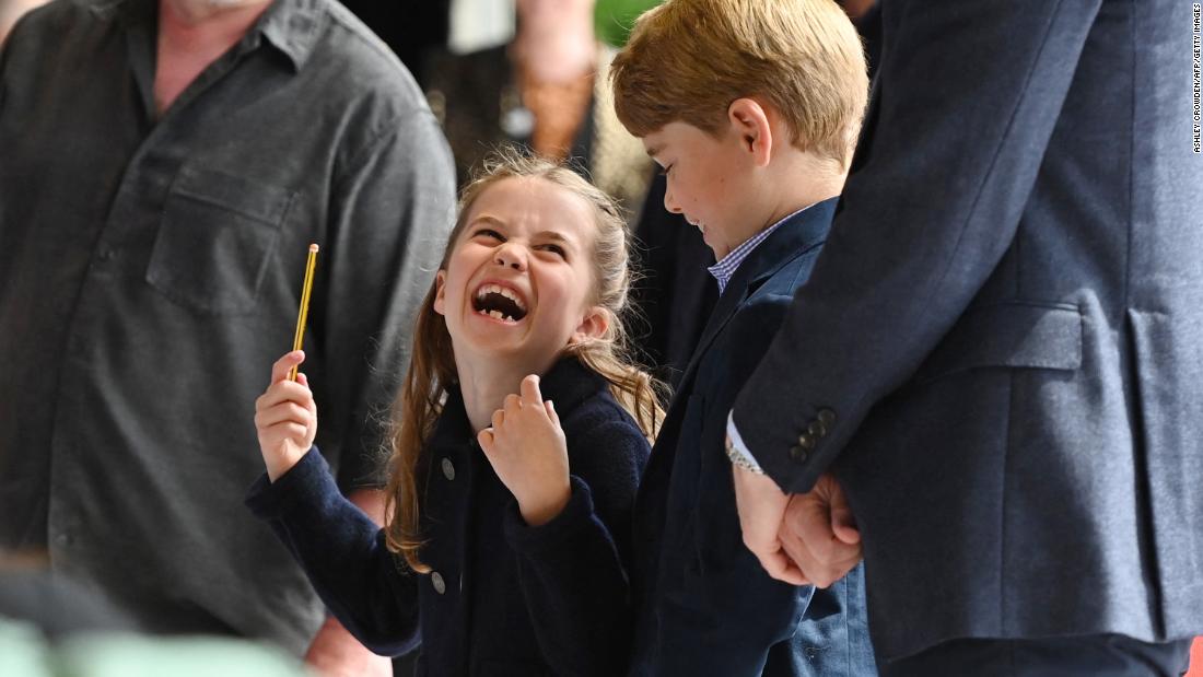 Princess Charlotte conducts a band next to her brother Prince George as they visited Cardiff Castle in Wales.
