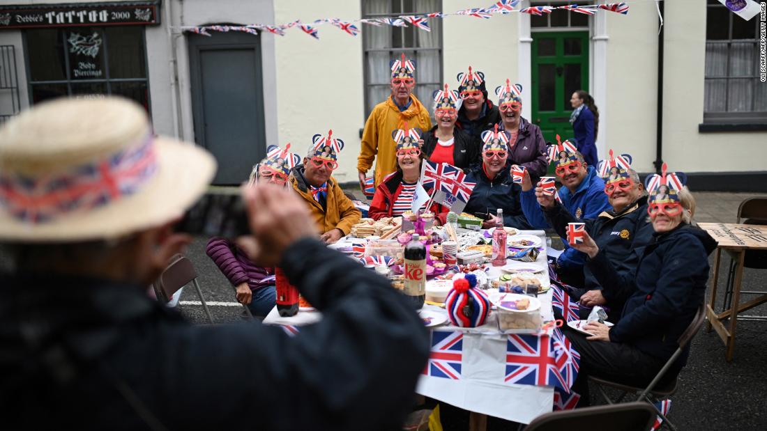 Revelers pose for pictures as they attend a party in Ashby-de-la-Zouch, England, on Sunday.