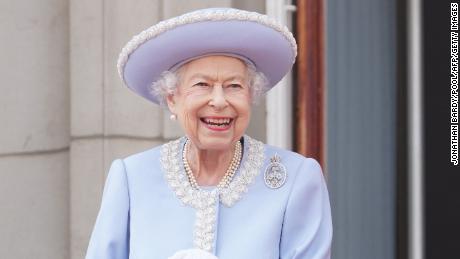 An intricate pearl lace trim and icy blue hue elevated one of Queen Elizabeth's go-to silhouettes: a long formal coat (pinned with a diamond brooch).