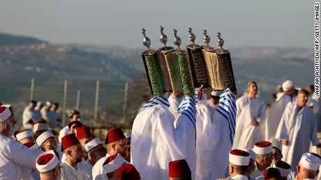 Samaritan worshippers lift up Torah scrolls as they gather at dawn on June 5 to pray on top of Mount Gerizim near the northern West Bank city of Nablus. Worshippers celebrated Shavuot, which according to Samaritan tradition marks the giving of the Torah to the Israelites at Mount Sinai seven weeks after their biblical exodus from Egypt. Samaritans are a community of a few hundred people living in Israel and in the Nablus area, who trace their lineage to the biblical ancient Israelites. 