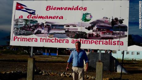 CNN&#39;s Patrick Oppmann near the US Navy base at Guantanamo in front of a Cuban government sign that reads, &quot;Welcome to Caimanera, the first anti-imperialist trench.&quot;